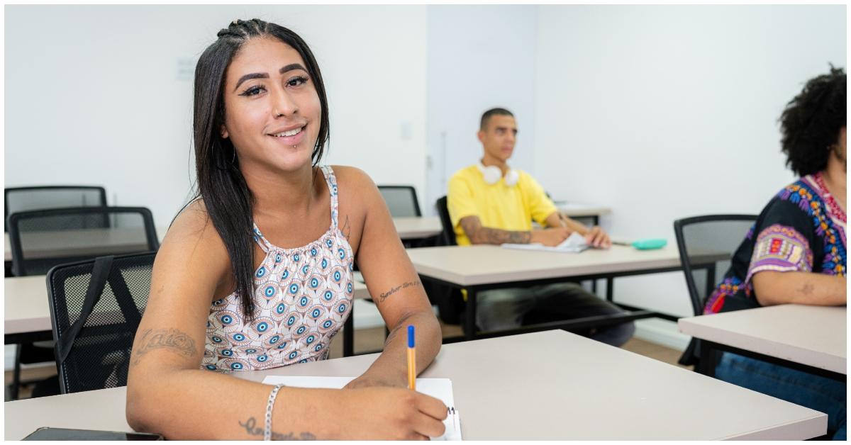 A student writing in a classroom