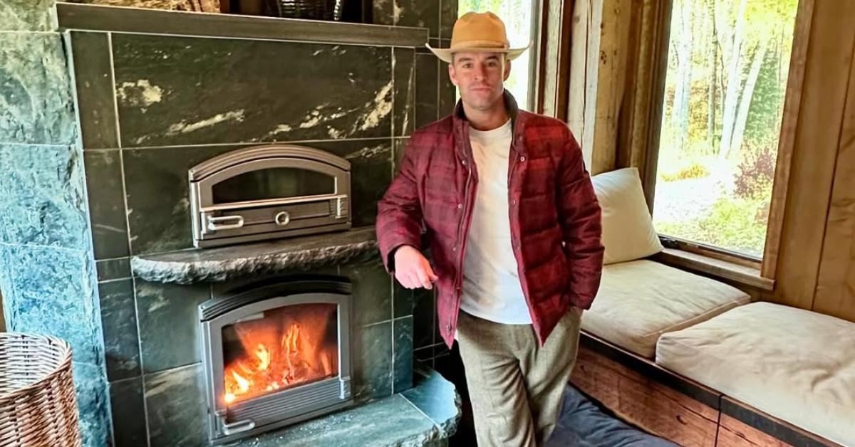 Jesse lally stands in front of a fireplace in Colorado