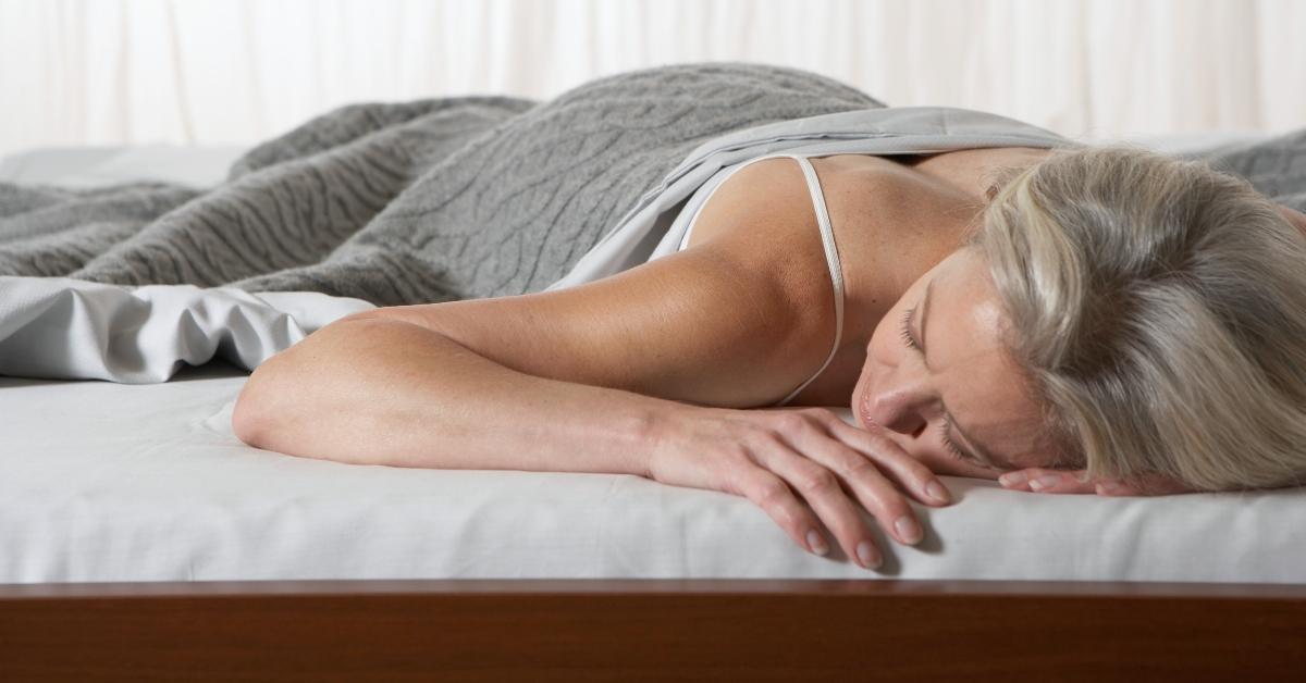 woman sleeping with head on mattress