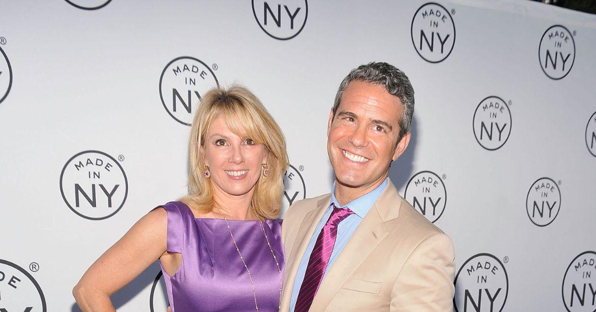 (l-r): Ramona Singer and Andy Cohen at an event smiling.