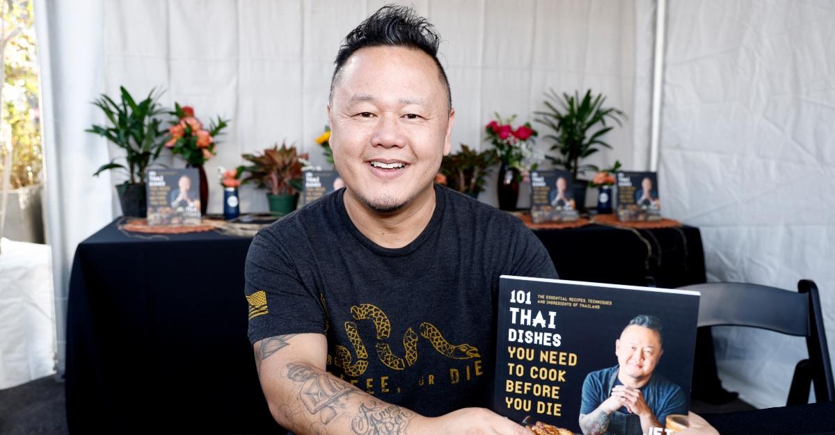Chef Jet Tila posing with his book, "Thai Dishes You Need To Cook Before You Die"