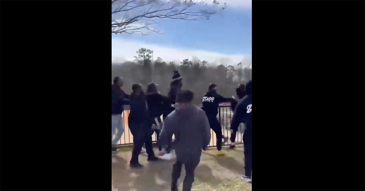 Cam Newton getting pulled away from a fight by security. 