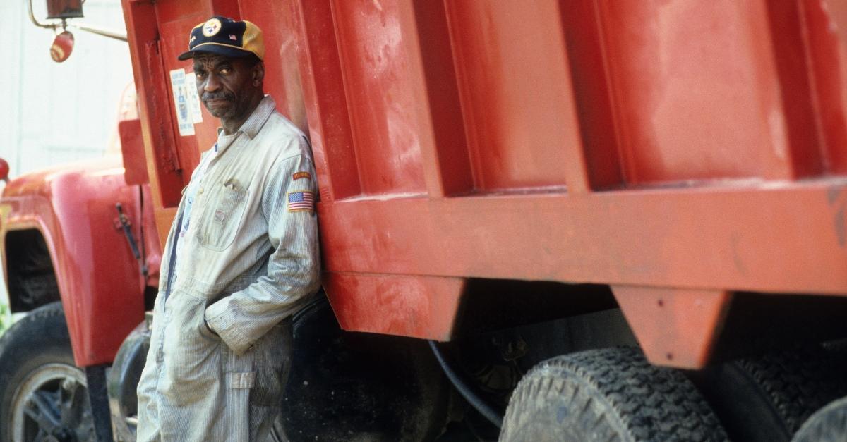 Bill Cobbs leaning on truck in a scene from the film 'Dominick And Eugene', 1988