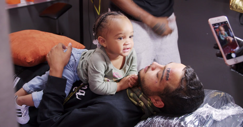 Bar Smith with his baby and fresh face tattoos