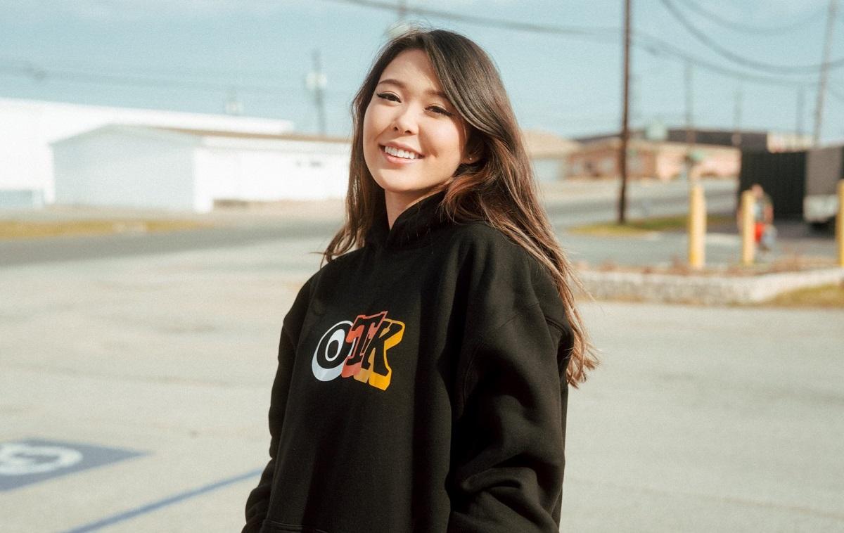 Image of ExtraEmily smiling while wearing a black OTK hoodie.