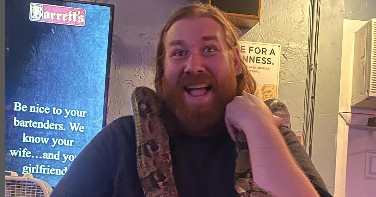 Ben Kissel holding a large snake at a bar.