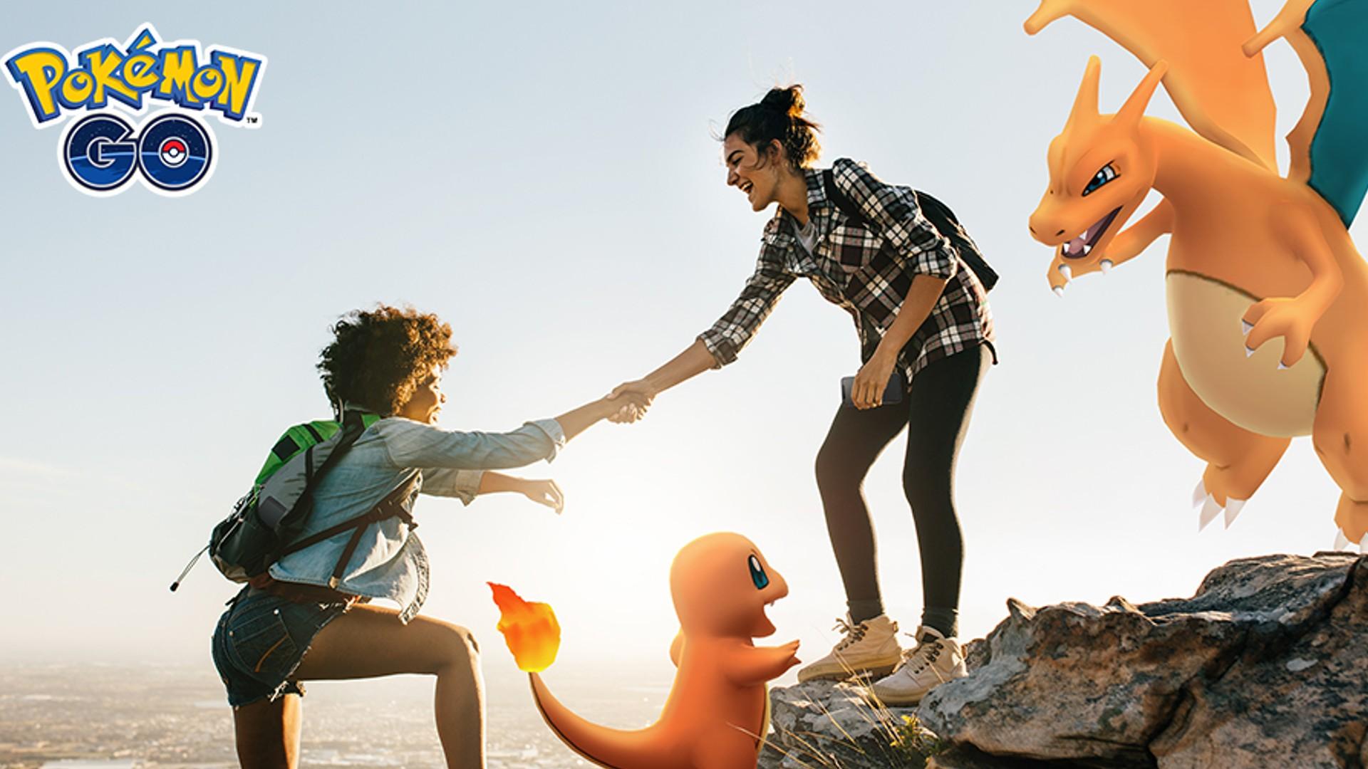 'Pokémon GO' Trainer helping another climb up a cliff.