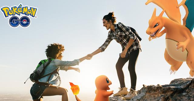 'Pokémon GO' Trainer helping another climb up a cliff.