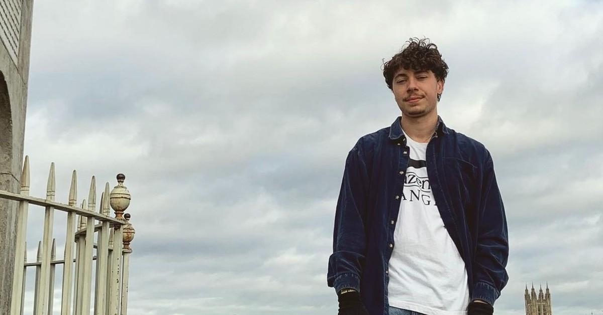 Harvey Almond in a blue jacket and white t-shirt. 