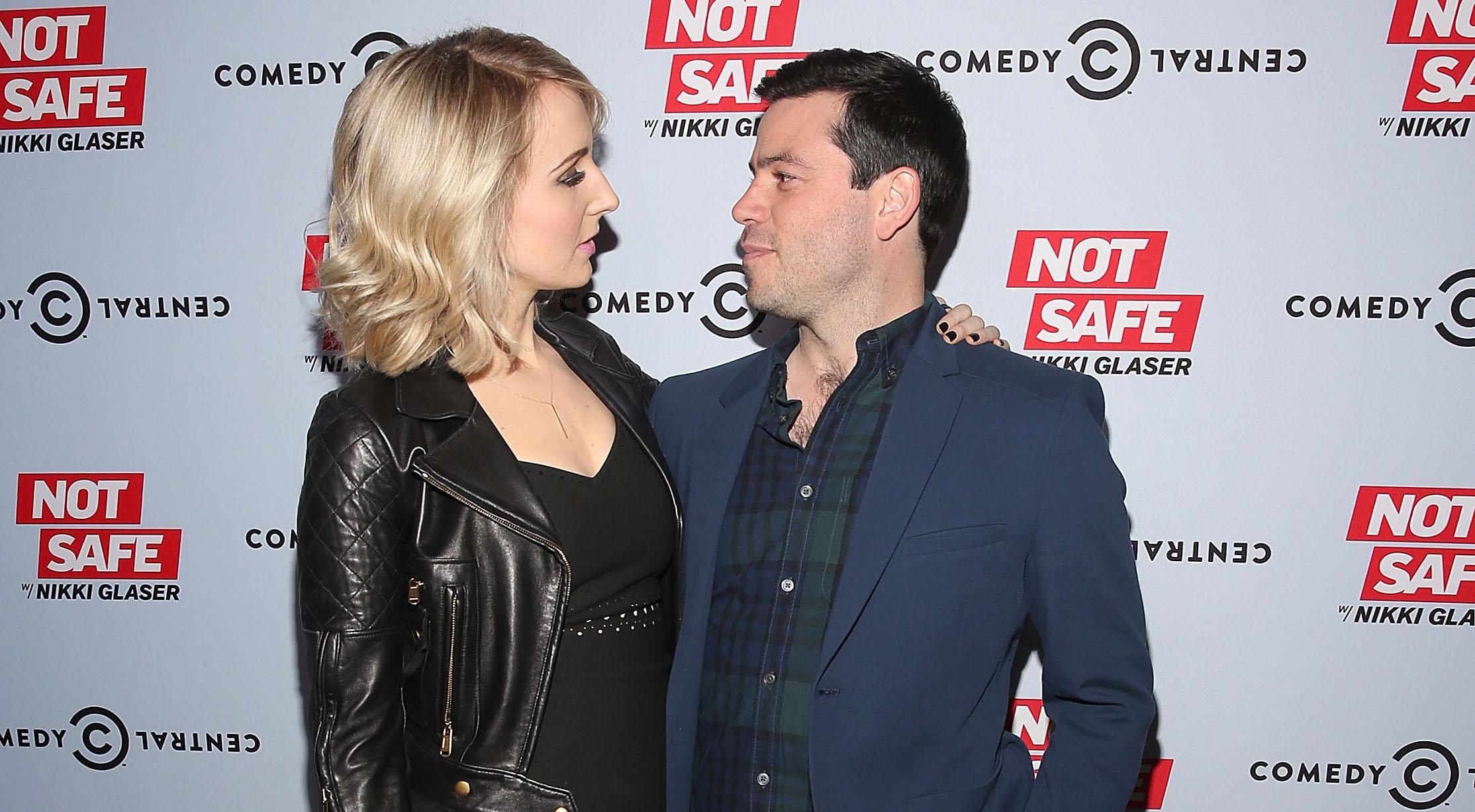 Nikki Glaser and Chris Convy looking into each other's eyes at an event. 