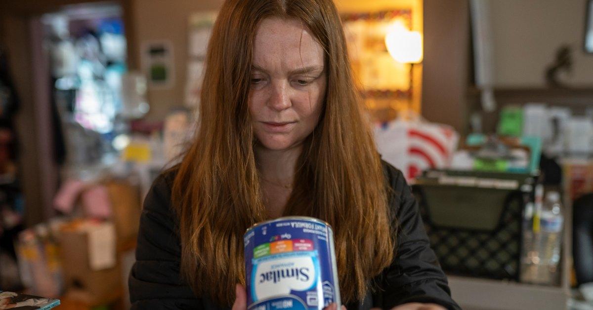 Woman holding baby formula 