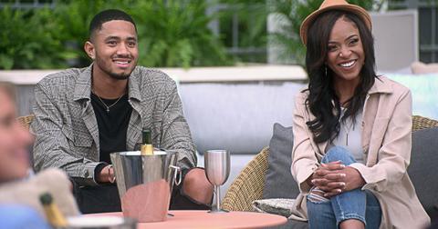 Randall and Shanique from The Ultimatum Season 1 sit on a couch outside