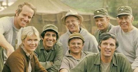 The cast of M*A*S*H poses in on-set in their uniforms