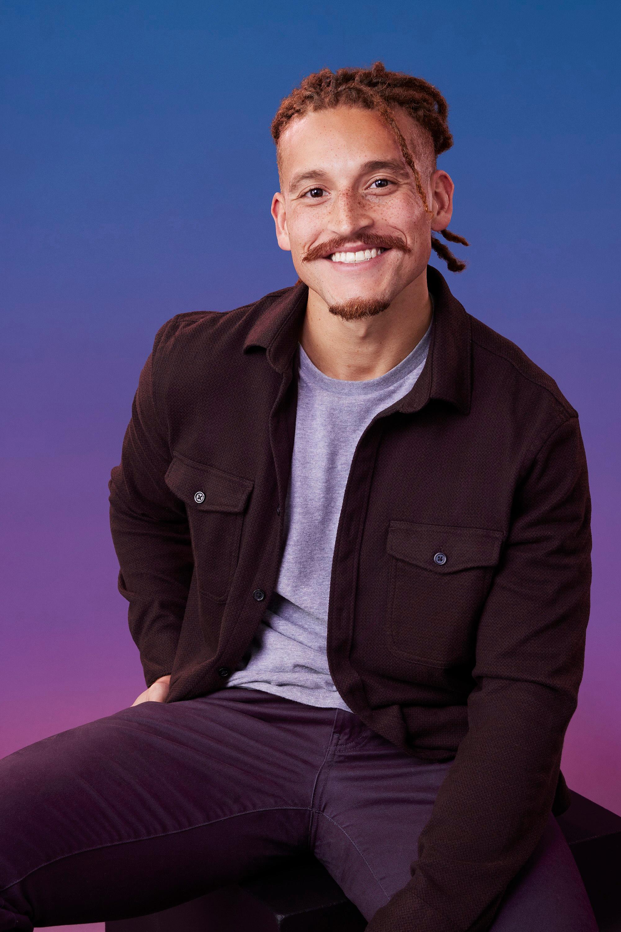 Matt poses in front of a blue-purple ombré background for his official 'The Bachelorette' Season 21 portrait.