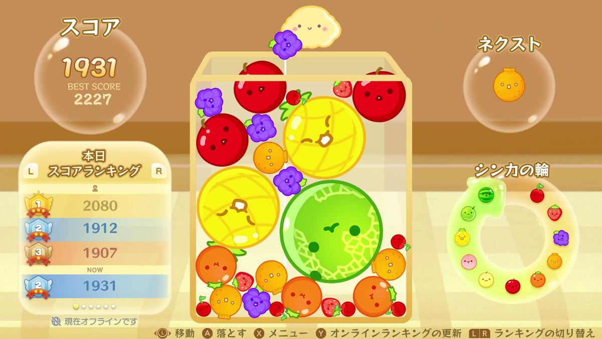 Player stacking various kinds of smiling fruit in 'Suika Game.'