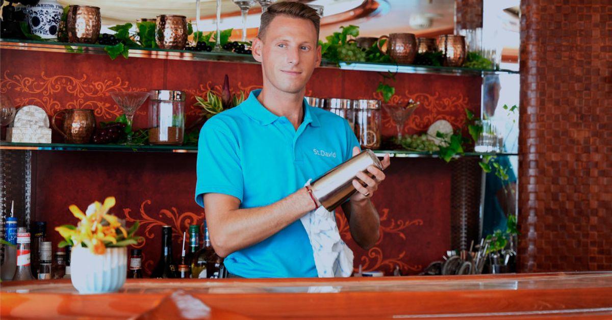 Fraser Olender cleaning out a drink mixer behind the bar on 'Below Deck'