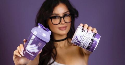 SSSniperWolf posing with her G-Fuel products