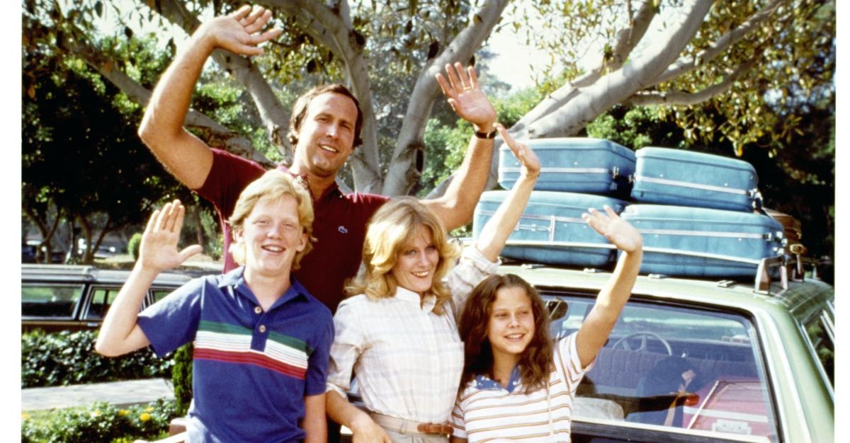 Anthony Michael Hall, Chevy Chase, Beverly D'Angelo, and Dana Barron waving from car in a scene from the film 'Vacation', 1983.