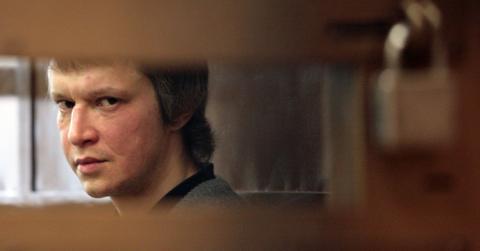 Alexander Pichushkin looks on from a cell in a Moscow court room awaiting his sentence, Oct. 29, 2007.