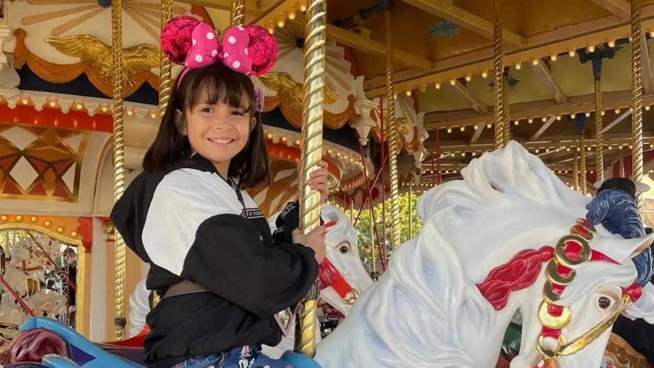 Liz Woods's daughter Ryleigh on a merry-go-round at Disney