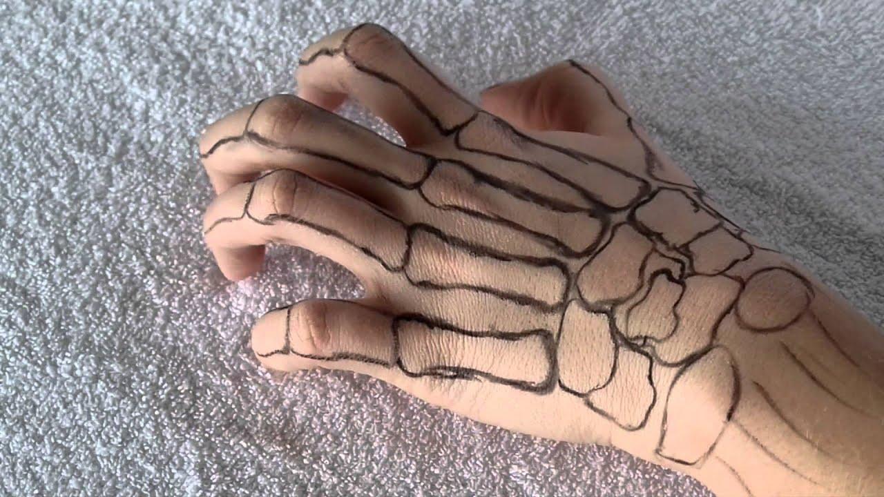 skeleton hand holding drawings