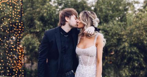 Michael Clifford and his wife kissing at their wedding