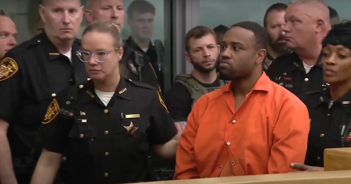 Rodney Hinton is led past a line of police as he exits a courtroom