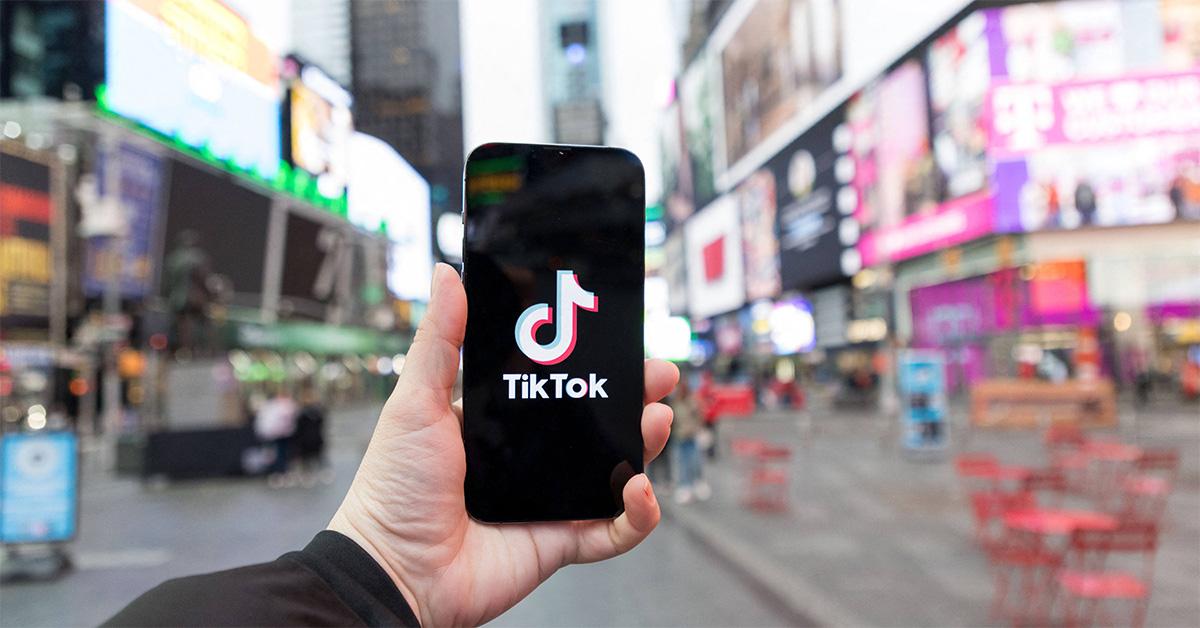 A TikTok logo on a phone in Times Square. 