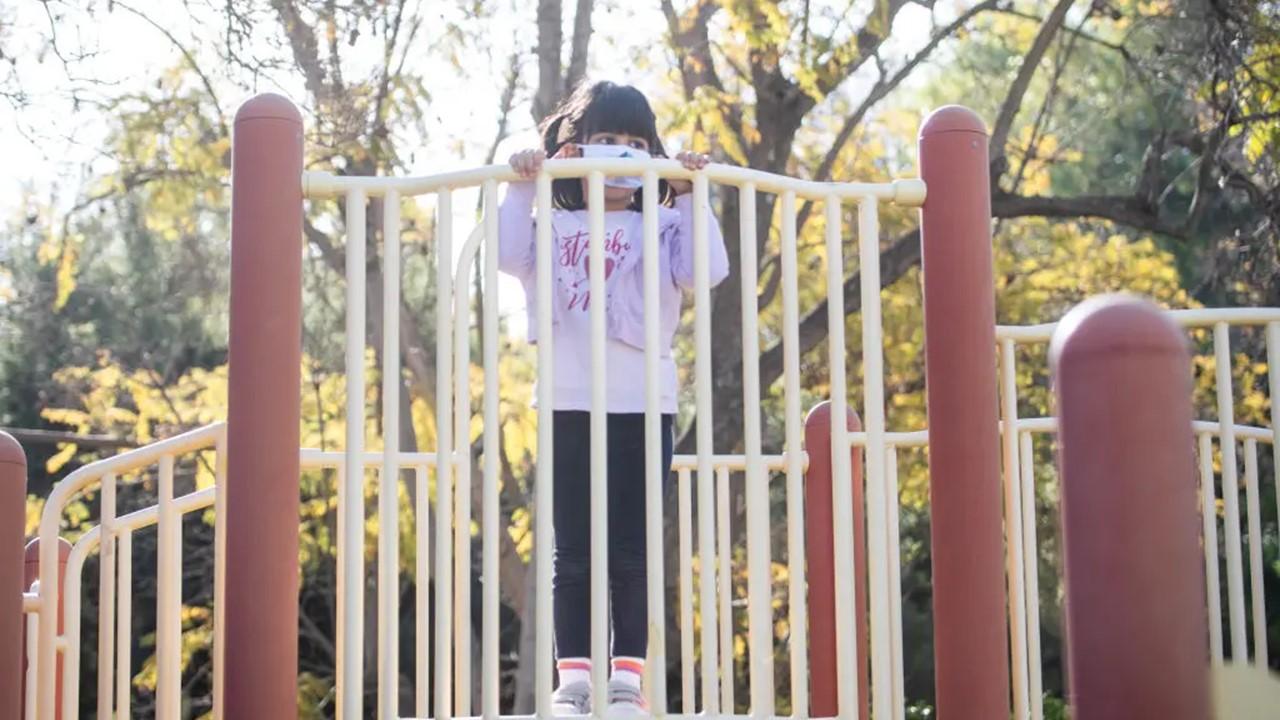 A young girl playing at a playground