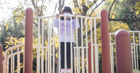 A young girl playing at a playground