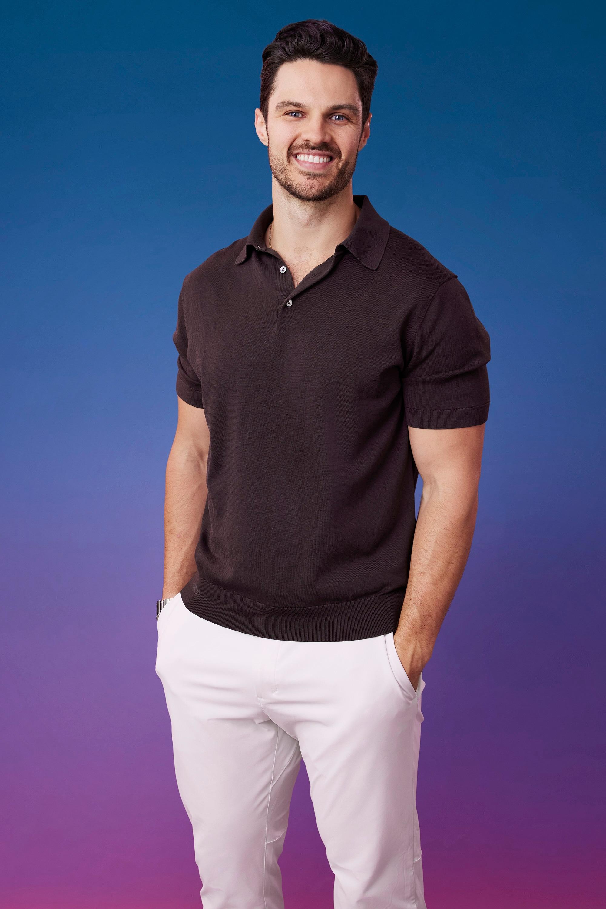 Spencer poses in front of a blue-purple ombré background for his official 'The Bachelorette' Season 21 portrait.