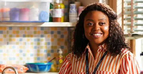 Janine (Quinta Brunson) in a red striped shirt, smiles in her classroom