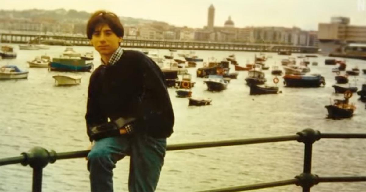 Alfredo Galán Sotillo sitting on railing next to a river and boats 