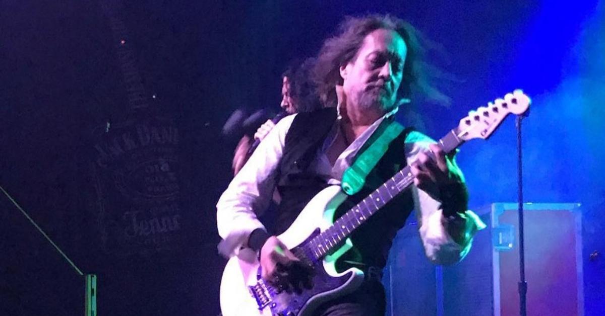 Jake E. Lee playing guitar on stage.