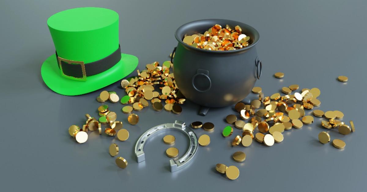 A pot of gold, gold coins, a horseshoe, and a green hat