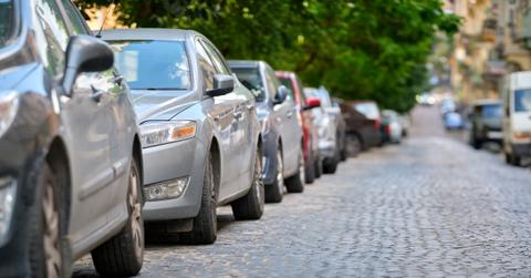 Cars Parked Cobblestone Street Getty