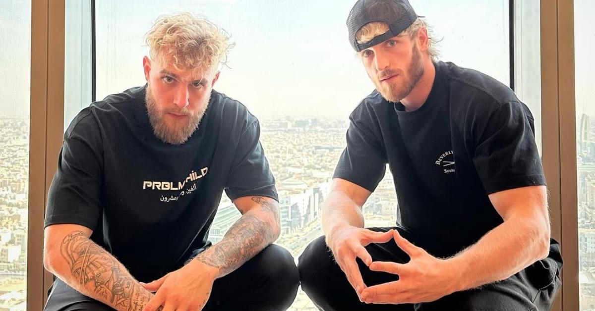 Jake and Logan Paul sit in a window together.
