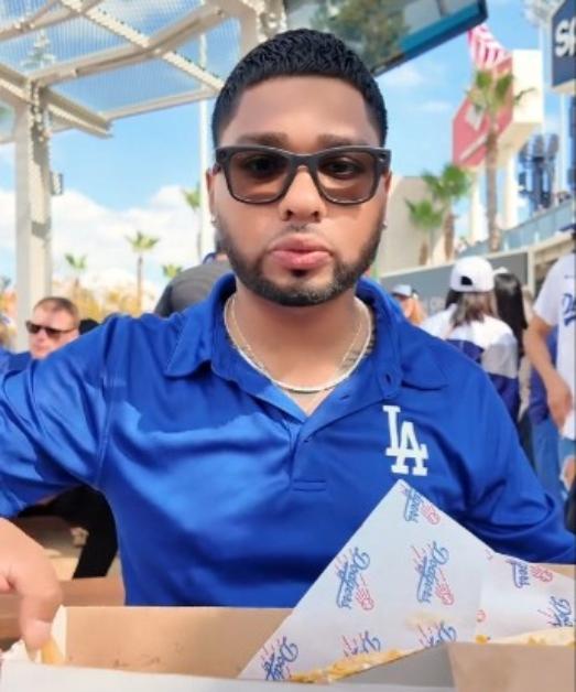 Noe Murillo eats while visiting Dodger's Stadium before being banned