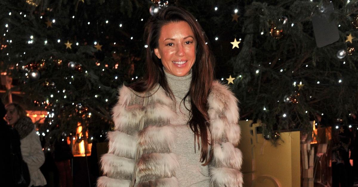 Monika Jakisic wearing a fur coat and standing near Christmas decorations outdoors