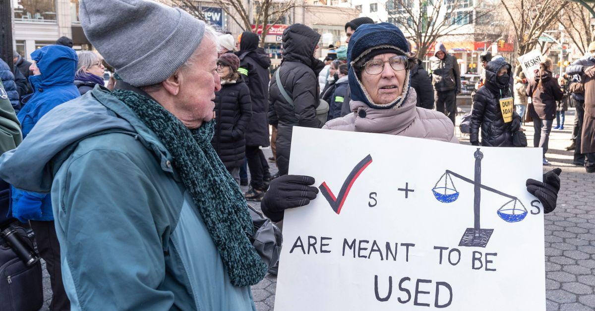 Protesters holding signs in New York City. 