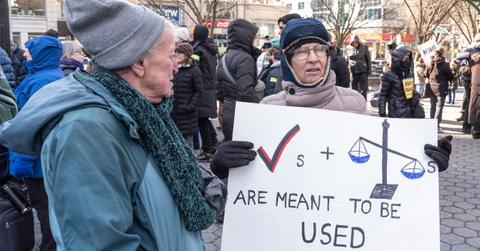 Protesters holding signs in New York City.