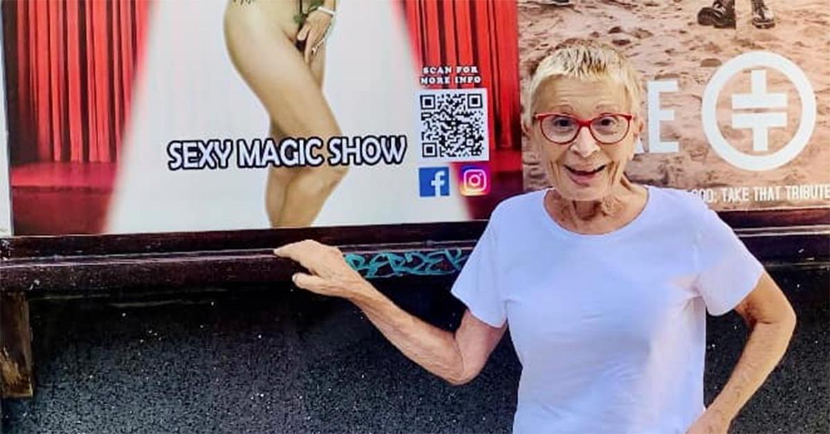 Sticky Vicky posing in front of a poster 