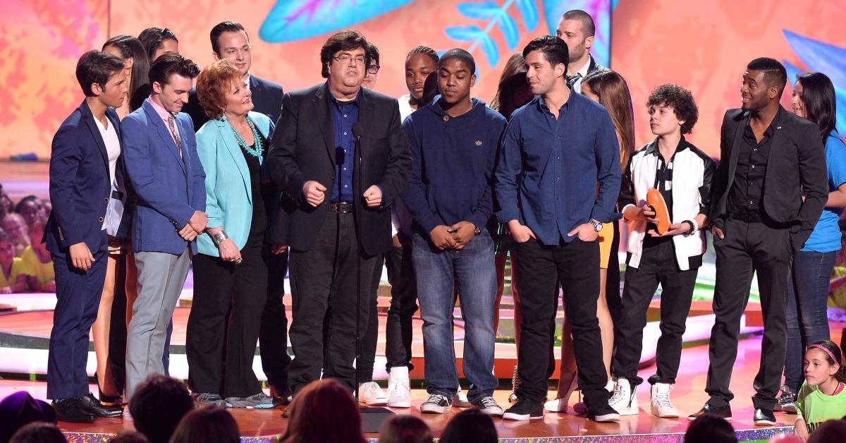 Writer/producer Dan Schneider (C) accepts the Lifetime Achievement Award onstage with actors from his shows during Nickelodeon's 27th Annual Kids' Choice Awards March 2014