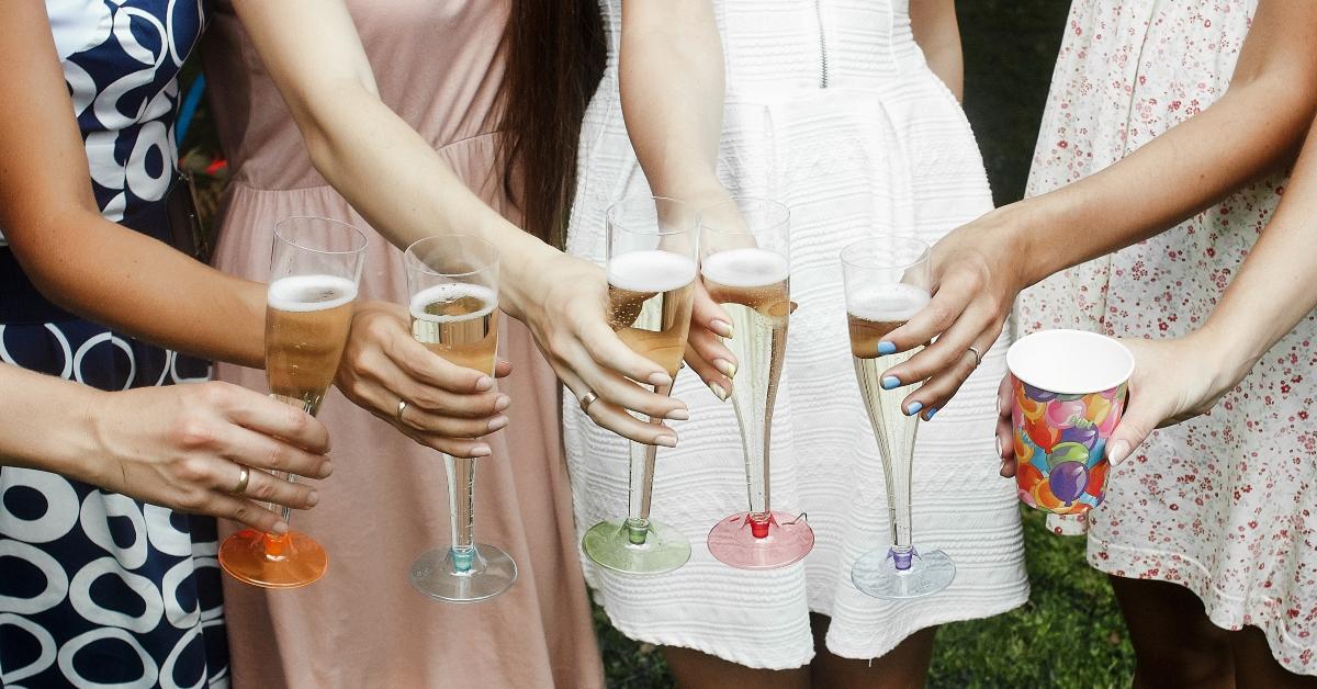 women cheers with drinks at outdoor reception