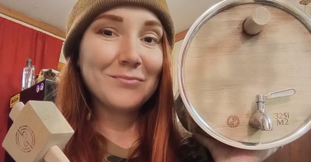 moonshiners' amanda bryant holds BadMotivator Barrel to make apple brandy