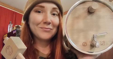 moonshiners' amanda bryant holds BadMotivator Barrel to make apple brandy