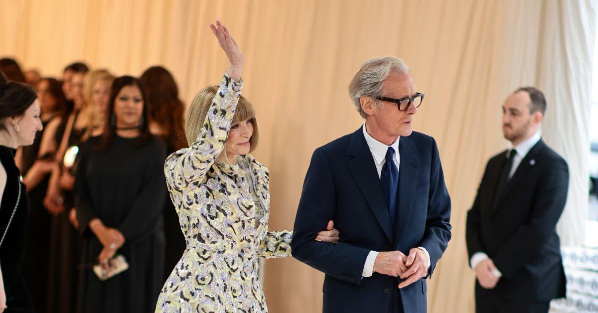 (l-r): Anna Wintour waving in a yellow and grey jacket alongside Bill Nighy in a black suit at the Met Gala. 