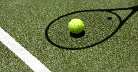 Tennis ball on tennis rack shadow
