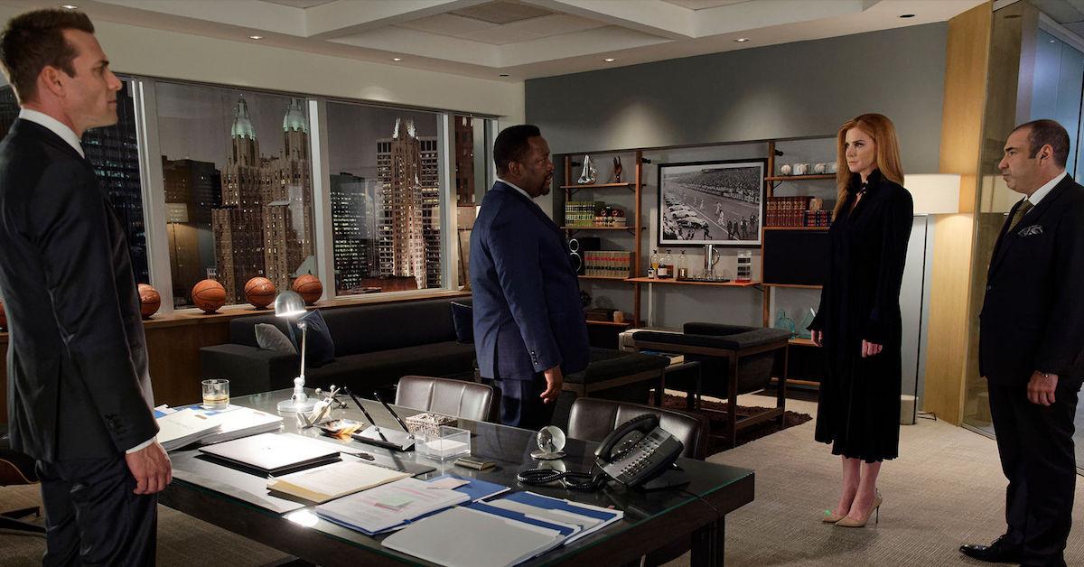 Robert Zane in an office with Harvey, Donna, and Luis.