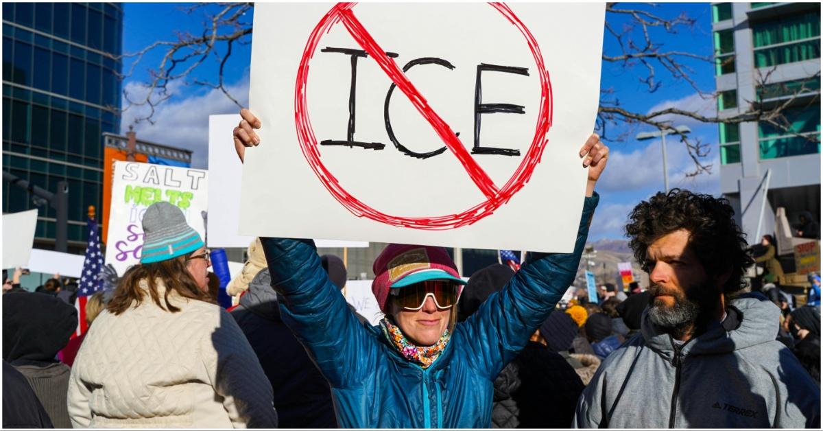 ICE protester holding up a sign